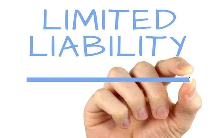 When a member has not contributed enough committed capital, is a limited liability company with 2 or more members required to register a change in charter capital?